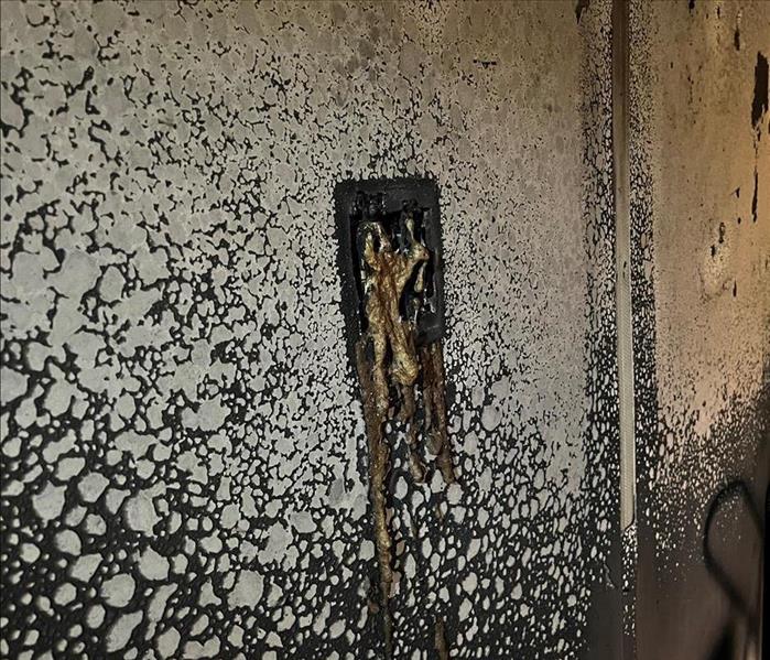 fire damage on wall and lightswitch